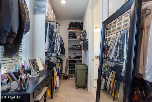 walk in closet featuring light carpet