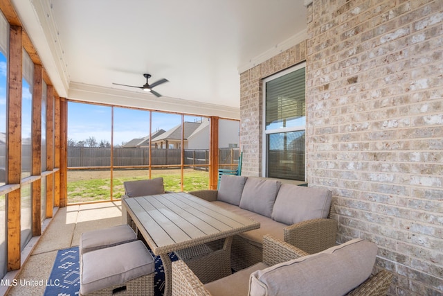 sunroom featuring ceiling fan