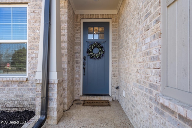 entrance to property featuring brick siding