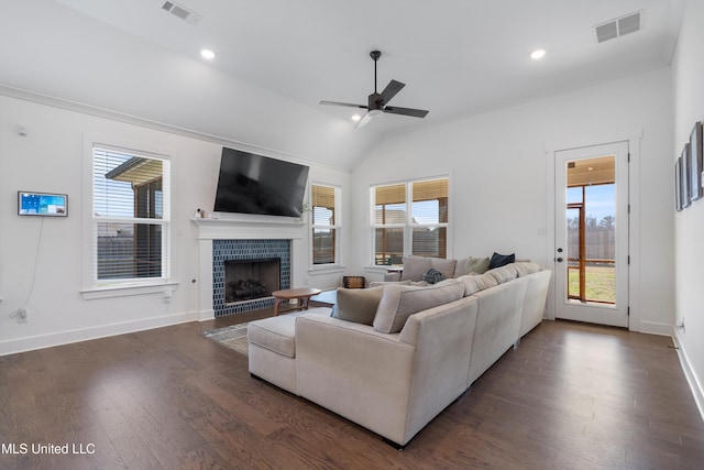 living room with visible vents, dark wood-type flooring, and a healthy amount of sunlight