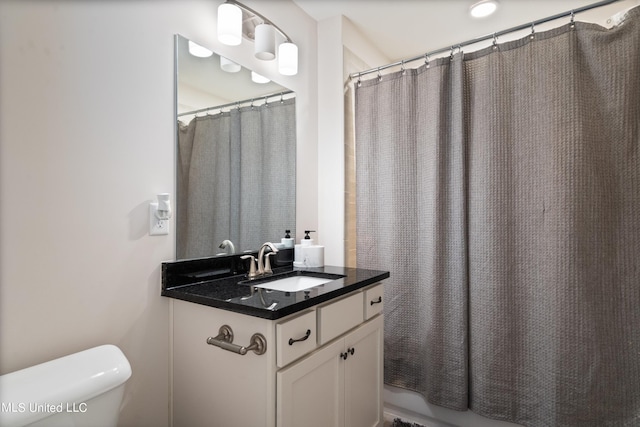 bathroom with vanity, toilet, and a shower with curtain