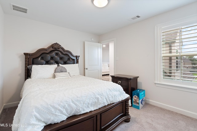 bedroom featuring light carpet