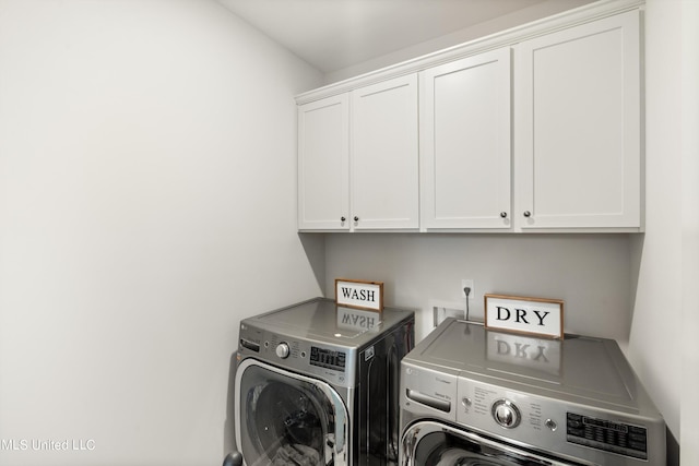 laundry area with washer and dryer and cabinets