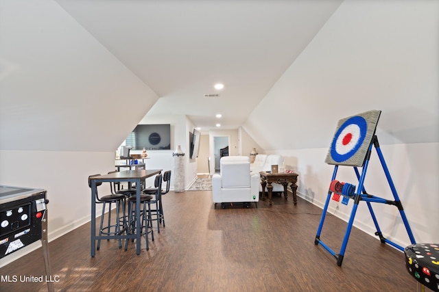 interior space featuring lofted ceiling and dark hardwood / wood-style flooring