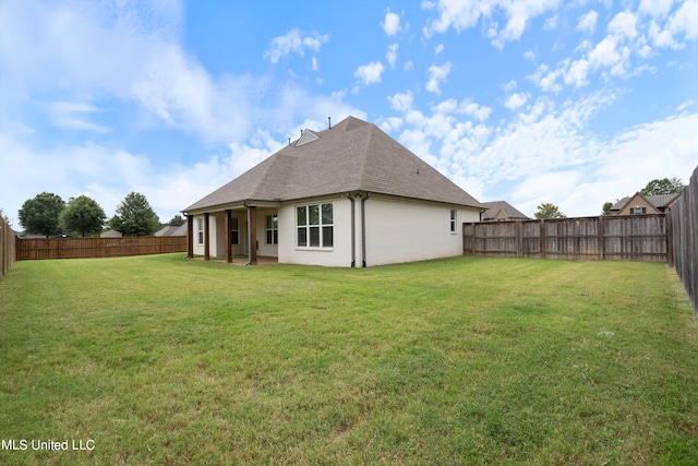 back of house featuring a yard