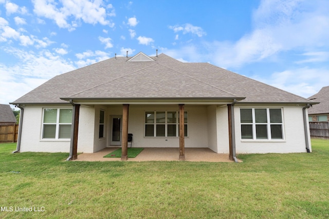 back of house with a patio and a lawn