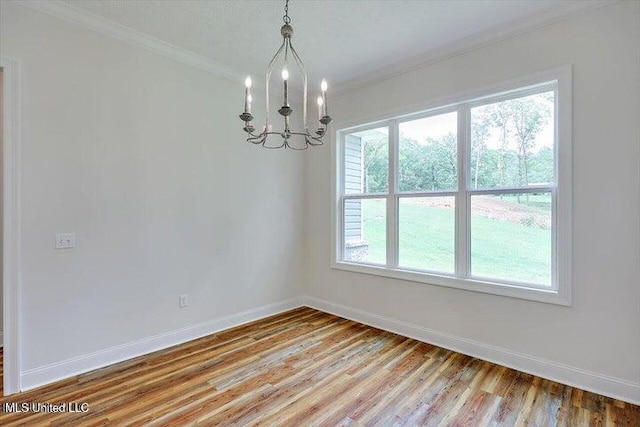 interior space featuring ornamental molding, a chandelier, hardwood / wood-style floors, and a healthy amount of sunlight