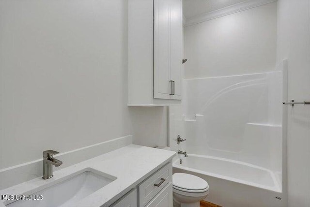 full bathroom featuring ornamental molding, vanity, toilet, and bathtub / shower combination