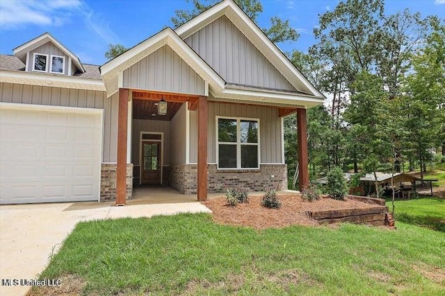 craftsman-style home featuring a garage and a front lawn