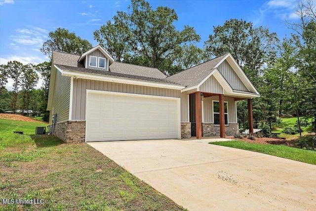 craftsman-style home with a garage, a front yard, and a porch