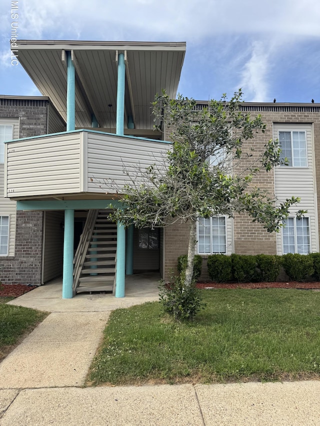 245 Mcdonnell Ave Unit 231, Biloxi, MS 39531 - view of front of property featuring brick siding and a front lawn