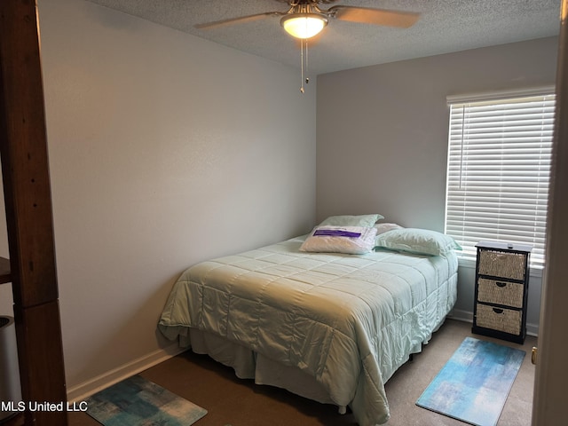 245 Mcdonnell Ave Unit 231, Biloxi, MS 39531 - carpeted bedroom with baseboards, a textured ceiling, and ceiling fan