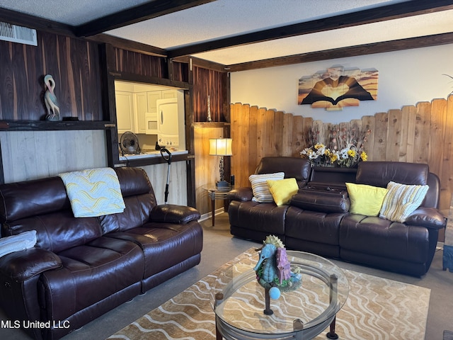 245 Mcdonnell Ave Unit 231, Biloxi, MS 39531 - living area with beamed ceiling, carpet, a textured ceiling, and wooden walls