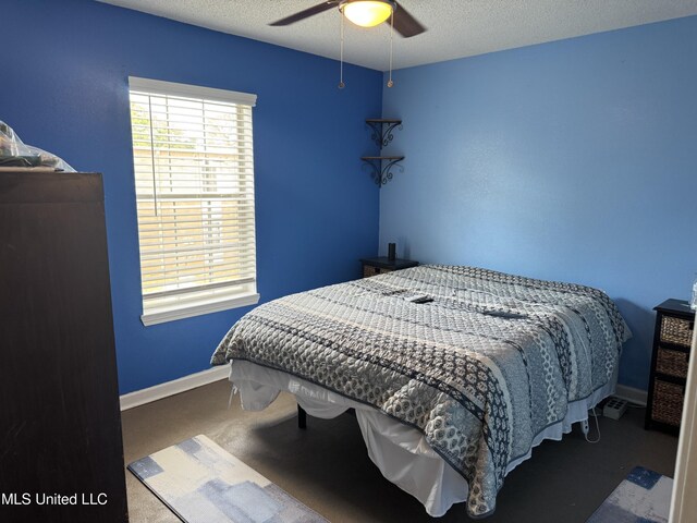 245 Mcdonnell Ave Unit 231, Biloxi, MS 39531 - bedroom featuring carpet, baseboards, a textured ceiling, and a ceiling fan