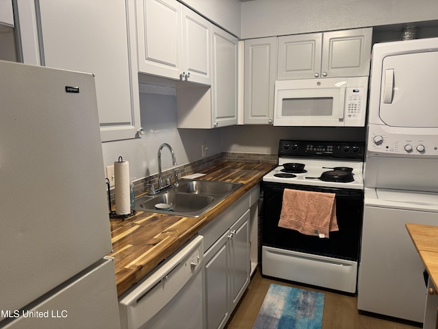 245 Mcdonnell Ave Unit 231, Biloxi, MS 39531 - kitchen featuring white appliances, a sink, butcher block counters, and stacked washer and clothes dryer