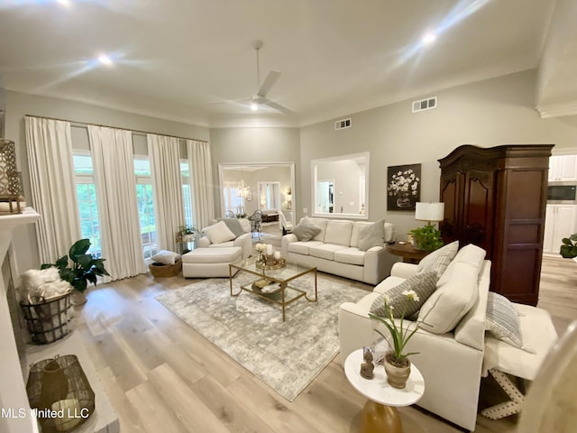 living area with a ceiling fan and light wood-style flooring