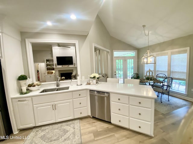 kitchen with dishwasher, a sink, a fireplace, light wood-style flooring, and white cabinetry