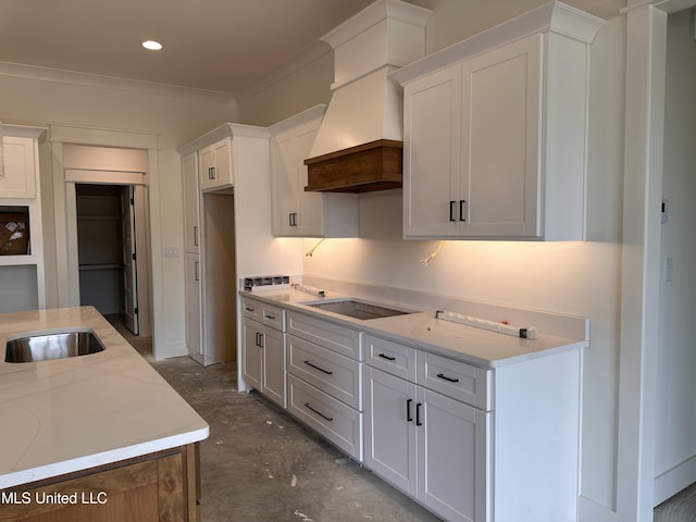 1805 Bakersfield Way, Nesbit, MS 38651 - kitchen featuring custom range hood, black electric stovetop, white cabinetry, crown molding, and concrete flooring