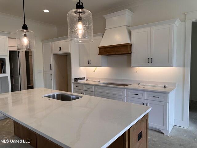1805 Bakersfield Way, Nesbit, MS 38651 - kitchen featuring cooktop, a center island with sink, white cabinets, custom range hood, and ornamental molding