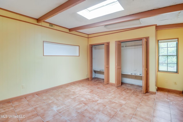 3008 Papania Ln, Gulfport, MS 39501 - unfurnished bedroom featuring multiple closets and beam ceiling
