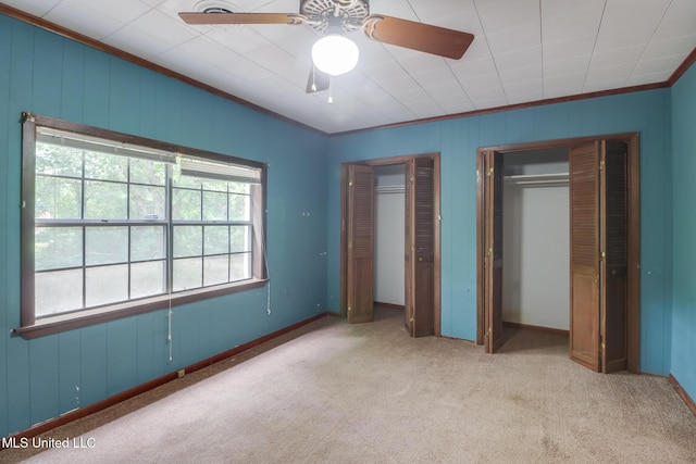 3008 Papania Ln, Gulfport, MS 39501 - unfurnished bedroom with ornamental molding, two closets, carpet, baseboards, and ceiling fan