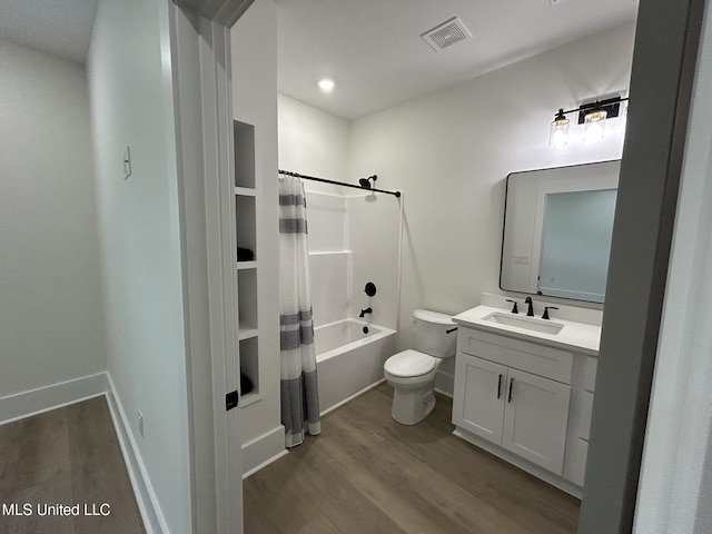 3076 Highland Ave, Diberville, MS 39540 - bathroom featuring wood finished floors, toilet, vanity, shower / bath combo with shower curtain, and baseboards