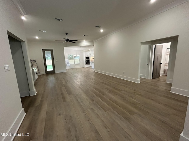 3076 Highland Ave, Diberville, MS 39540 - unfurnished living room featuring ceiling fan, dark wood-type flooring, recessed lighting, baseboards, and crown molding