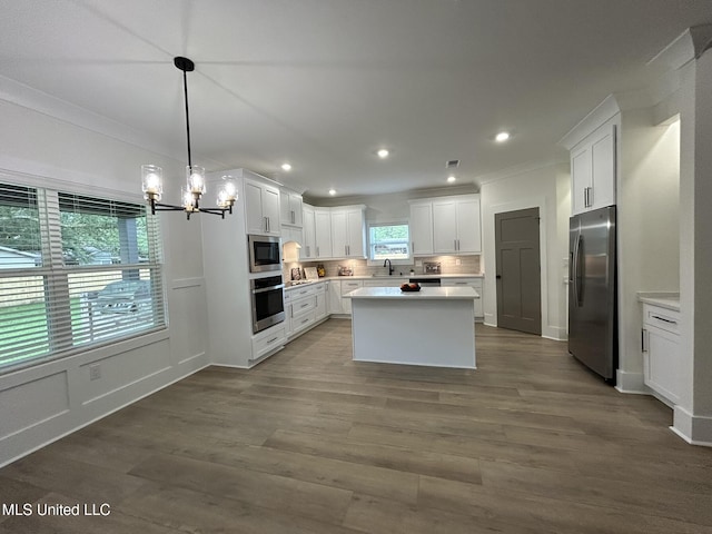 3076 Highland Ave, Diberville, MS 39540 - kitchen with stainless steel appliances, a chandelier, recessed lighting, light countertops, and white cabinets