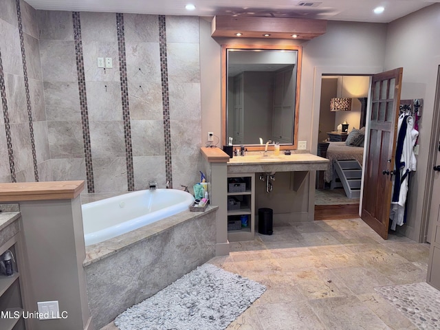 236 Sawbridge Dr, Ridgeland, MS 39157 - bathroom featuring a garden tub, a sink, and recessed lighting