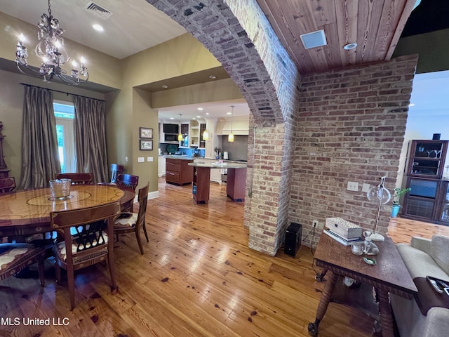 236 Sawbridge Dr, Ridgeland, MS 39157 - dining room with light wood-type flooring, a chandelier, baseboards, recessed lighting, and arched walkways