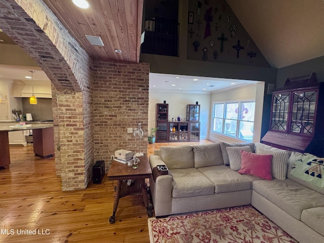 236 Sawbridge Dr, Ridgeland, MS 39157 - living room featuring light wood-style flooring, recessed lighting, high vaulted ceiling, and brick wall