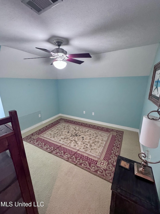 236 Sawbridge Dr, Ridgeland, MS 39157 - carpeted bedroom featuring vaulted ceiling, ceiling fan, baseboards, and a textured ceiling