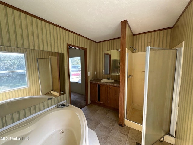 bathroom with vanity, independent shower and bath, ornamental molding, and tile patterned floors