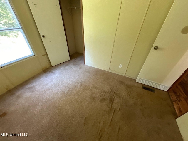 unfurnished bedroom with light carpet