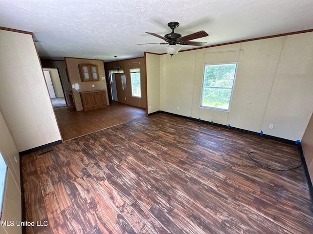 unfurnished living room with ceiling fan, a textured ceiling, and dark hardwood / wood-style floors