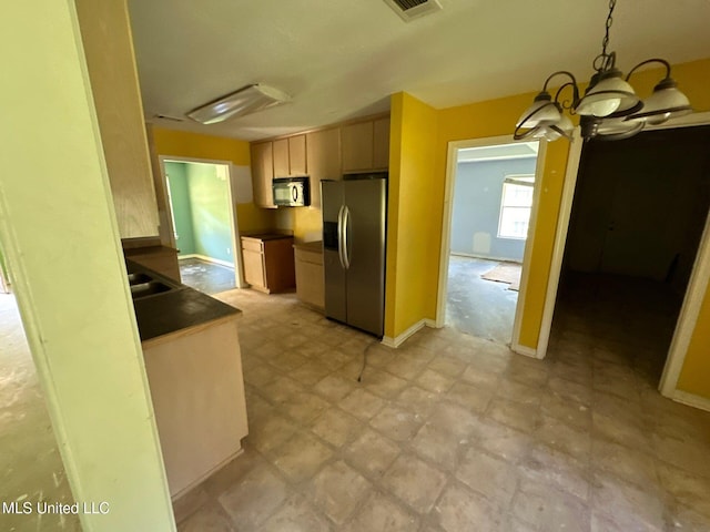 kitchen featuring light brown cabinetry, stainless steel refrigerator with ice dispenser, pendant lighting, and an inviting chandelier