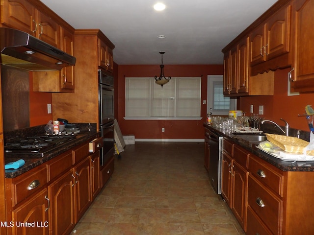 3820 Beamon Rd, Kosciusko, MS 39090 - kitchen with dark stone countertops, a sink, baseboards, under cabinet range hood, and black gas stovetop