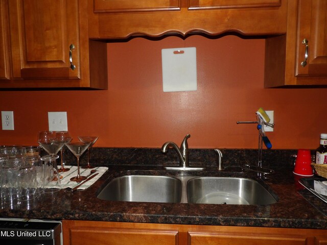 3820 Beamon Rd, Kosciusko, MS 39090 - kitchen with dishwashing machine, brown cabinets, and a sink