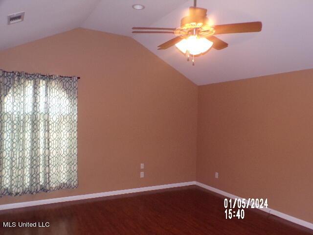 3820 Beamon Rd, Kosciusko, MS 39090 - spare room featuring baseboards, wood finished floors, ceiling fan, and lofted ceiling