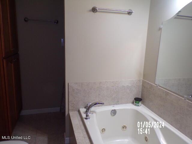 3820 Beamon Rd, Kosciusko, MS 39090 - bathroom with a tub with jets and tile patterned floors