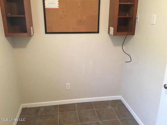 3820 Beamon Rd, Kosciusko, MS 39090 - washroom featuring baseboards and dark tile patterned flooring