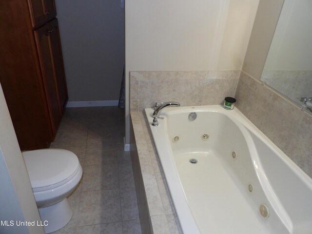 3820 Beamon Rd, Kosciusko, MS 39090 - bathroom with a tub with jets, tile patterned flooring, toilet, and baseboards