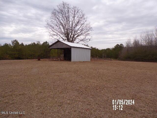 3820 Beamon Rd, Kosciusko, MS 39090 - view of pole building with a carport and a view of trees