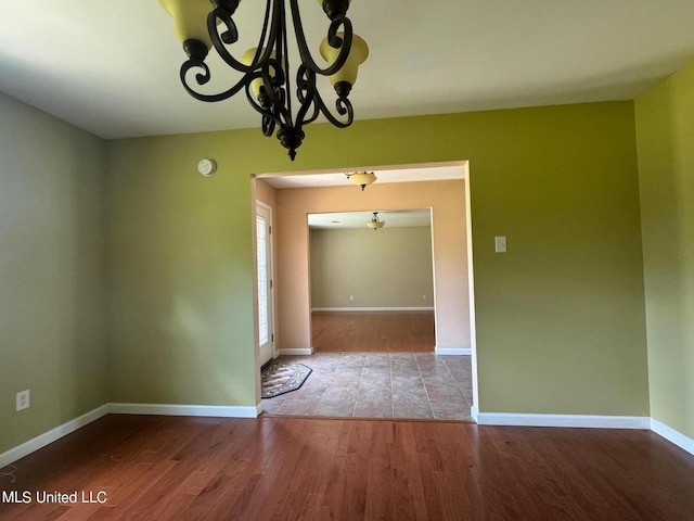3820 Beamon Rd, Kosciusko, MS 39090 - unfurnished dining area featuring wood finished floors, a chandelier, and baseboards