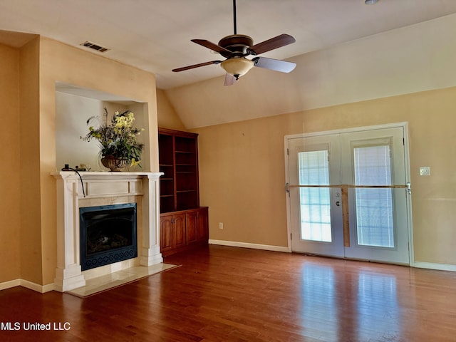 3820 Beamon Rd, Kosciusko, MS 39090 - unfurnished living room with a fireplace, ceiling fan, wood finished floors, vaulted ceiling, and french doors