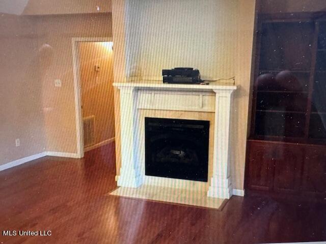 3820 Beamon Rd, Kosciusko, MS 39090 - interior details featuring baseboards, wood finished floors, and a fireplace with flush hearth