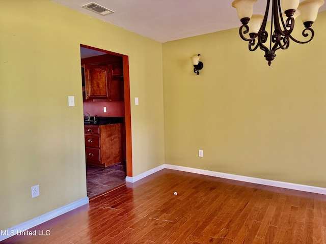 3820 Beamon Rd, Kosciusko, MS 39090 - unfurnished dining area featuring a sink, visible vents, a chandelier, baseboards, and dark wood-type flooring