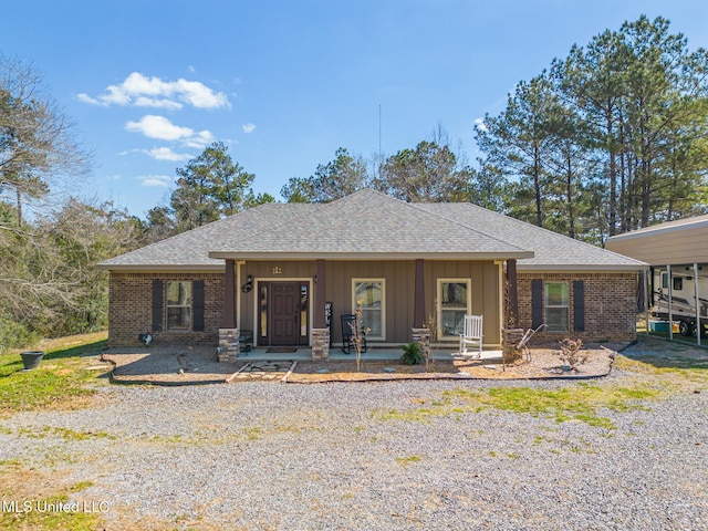 view of front of house featuring brick siding and a shingled roof