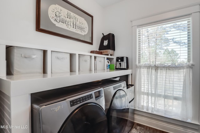 clothes washing area featuring separate washer and dryer and laundry area