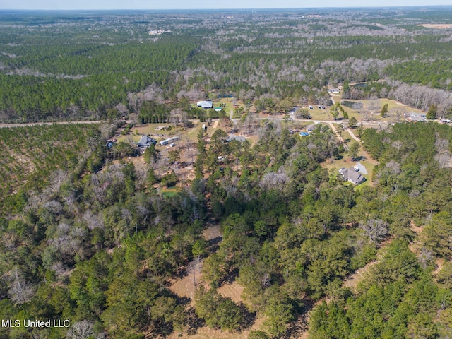 drone / aerial view featuring a forest view